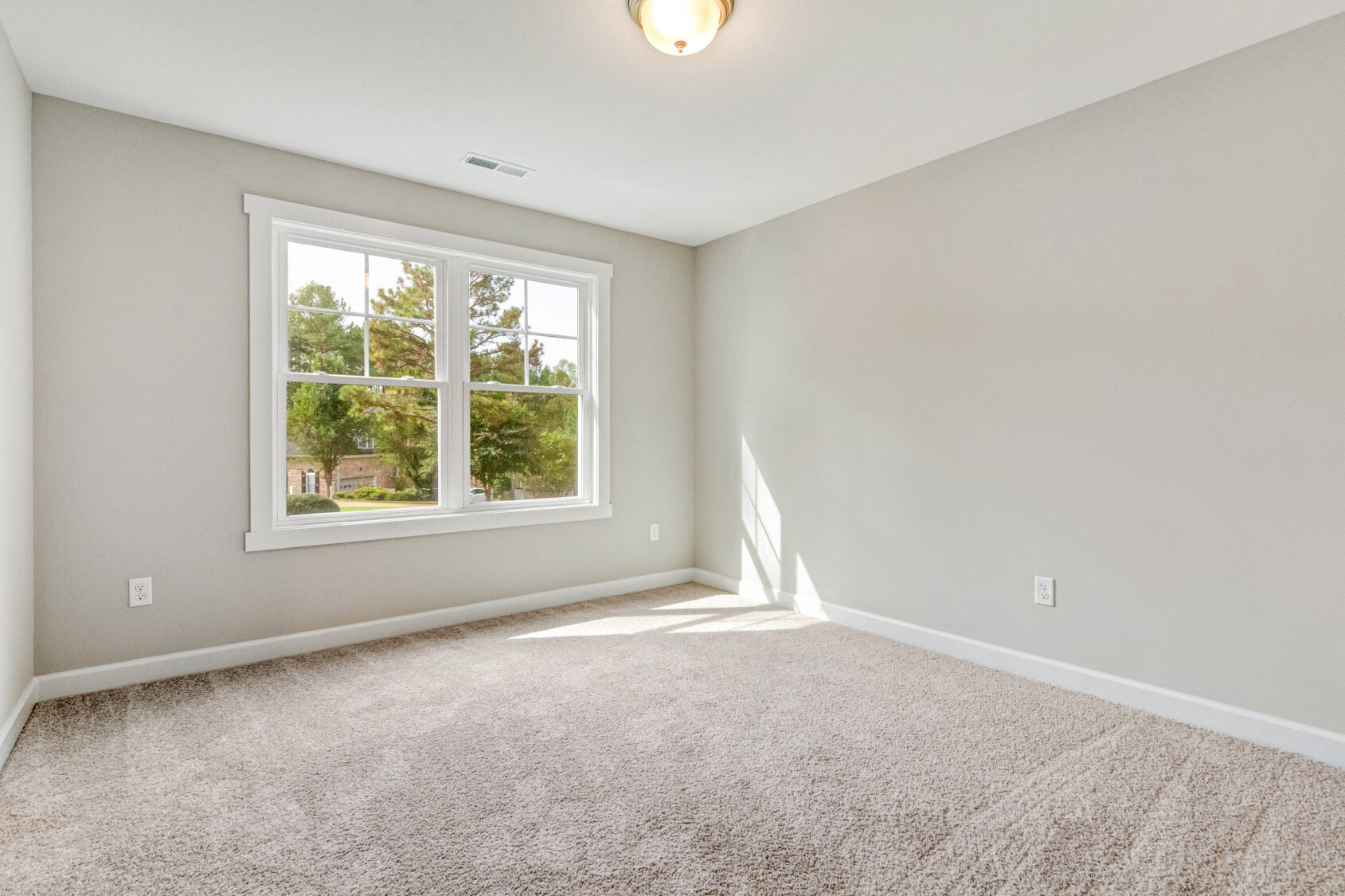 A room with a window and carpet