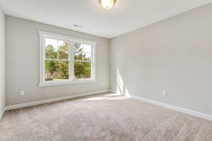 A room with a window and carpet