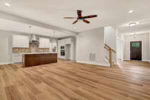 Spacious open-plan kitchen and living area in Somerset Hill’s Lot 7, featuring wood floors and modern lighting.